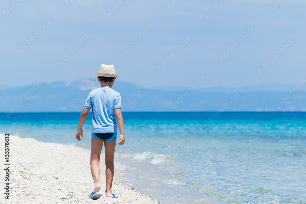 Boy walking on the beach