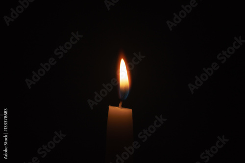 tall candle blown in the dark environment, focus on fron part