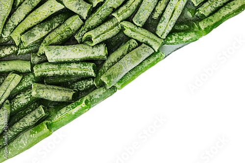 Border of fresh frozen green french bean with hoarfrost closeup on white background. Isolated. Healthy vitamin food.