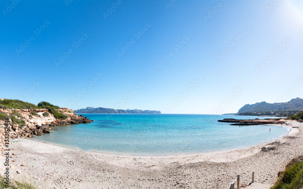Panoramic view of a Mallorca beach with turquoise water and bright blue sky