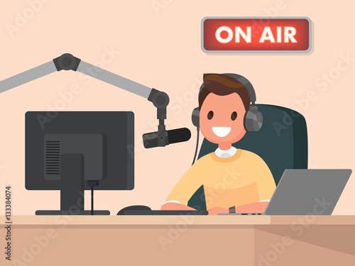 Broadcasting. Radio host behind a desk speaks into the microphon