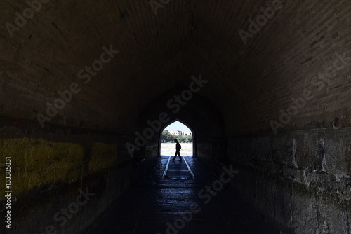 Perspective View Through a Dark Tunnel With Human Silhouette