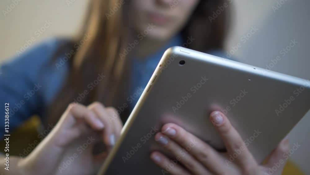 Woman using tablet computer touchscreen in cafe. Close-up. Woman using tablet computer touchscreen in cafe. Close-up.