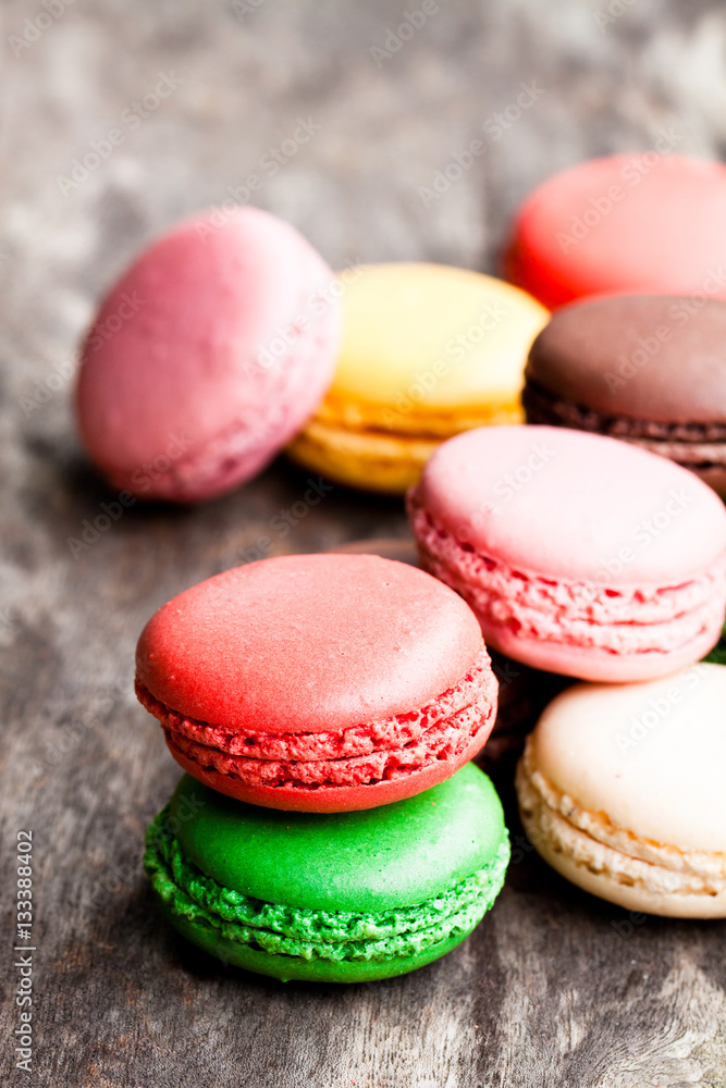 colorful macarons on rustic wooden backrgound colorful macarons on rustic wooden backrgound
