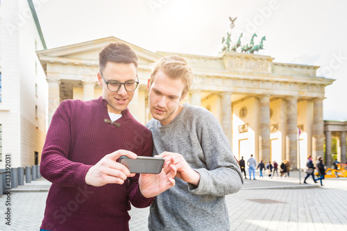 Wall Mural Two men looking at a smartphone in Berlin