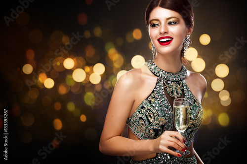 Woman in evening dress with champagne glasses - St valentine's day celebration. New Year and Chrismtas