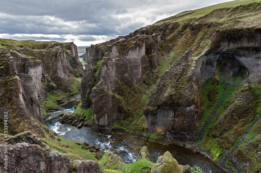 Fjaðrárgljúfur is a canyon in south east Iceland which is up to 100 m deep and about 2 kilometres long.
