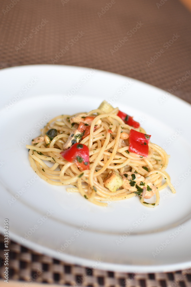 pasta salad with spaghetti, pepper, mozzarella, red onion, pine nuts