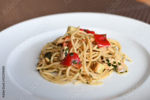 pasta salad with spaghetti, pepper, mozzarella, red onion, pine nuts