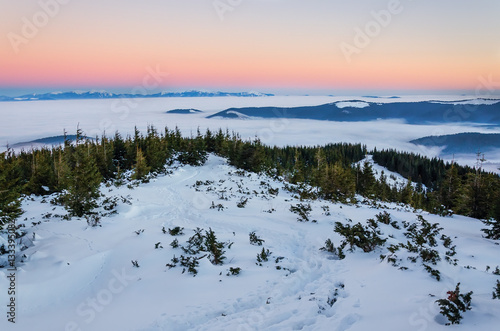 Snow lanscape at the top of a mountain. Sunrise