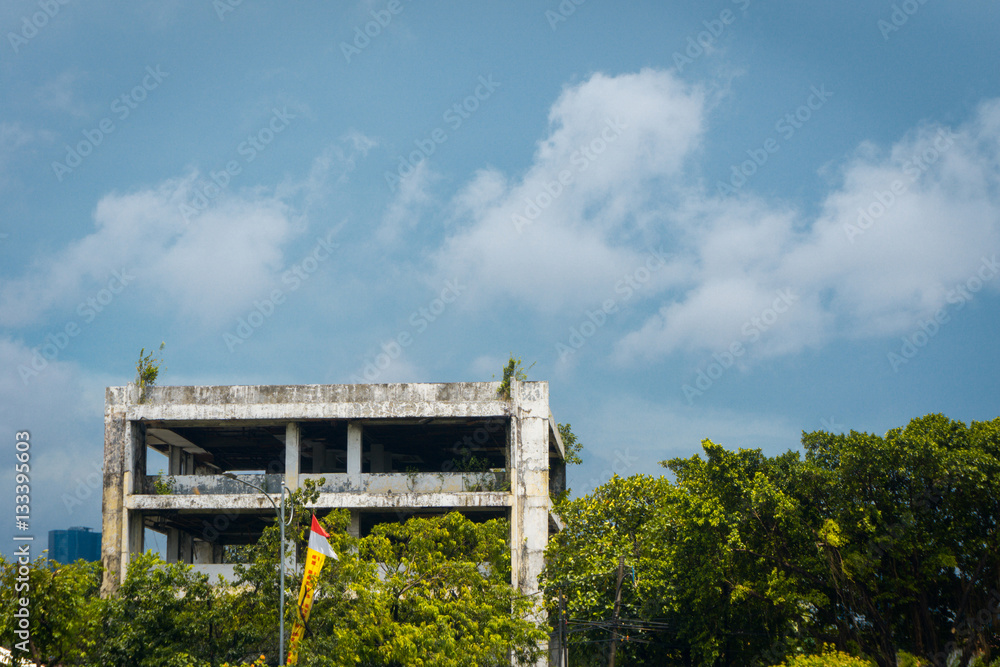 Abandoned office building with trees and cloudysky photo taken in Jakarta Indonesia Abandoned office building with trees and cloudysky photo taken in Jakarta Indonesia