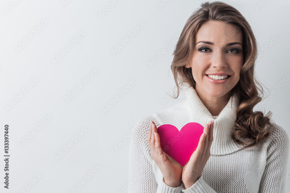 Smiling woman with paper heart Smiling woman with paper heart