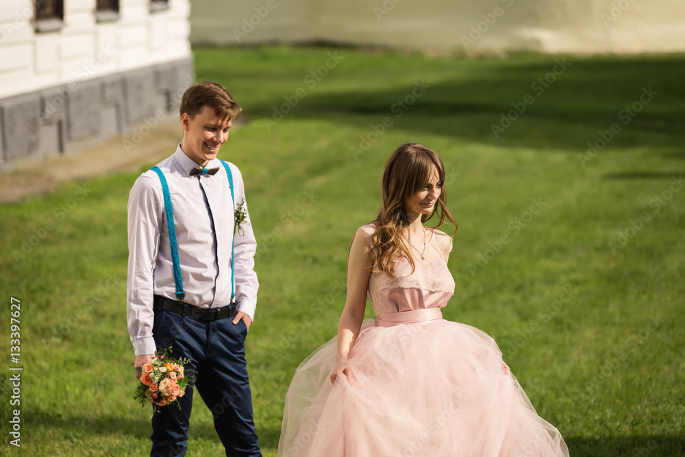 Wedding couple, stylish american bride and groom walking in park