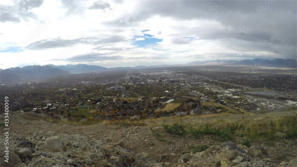 Timelapse of a dark day with sun glimpse above the city, filmed from the top of ensign peak, in Salt lake city, Utah, United states of America Timelapse of a dark day with sun glimpse above the city, filmed from the top of ensign peak, in Salt lake city, Utah, United states of America
