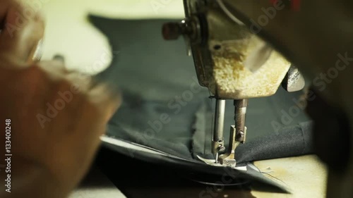 Sewing machine making stitches on a bespoke tailored suit