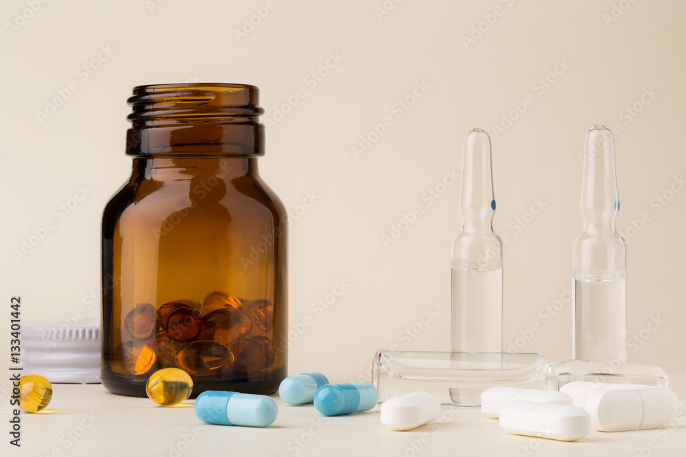 Bottle of pills from the brown glass and colorful capsules Bottle of pills from the brown glass and colorful capsules