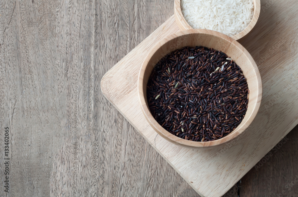 black grain of rice on wood table.