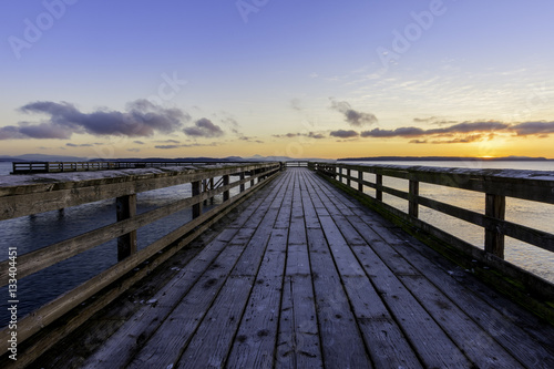 Early morning on frosty ocean pier with orange sky.Vancouver Island Canada © Paul