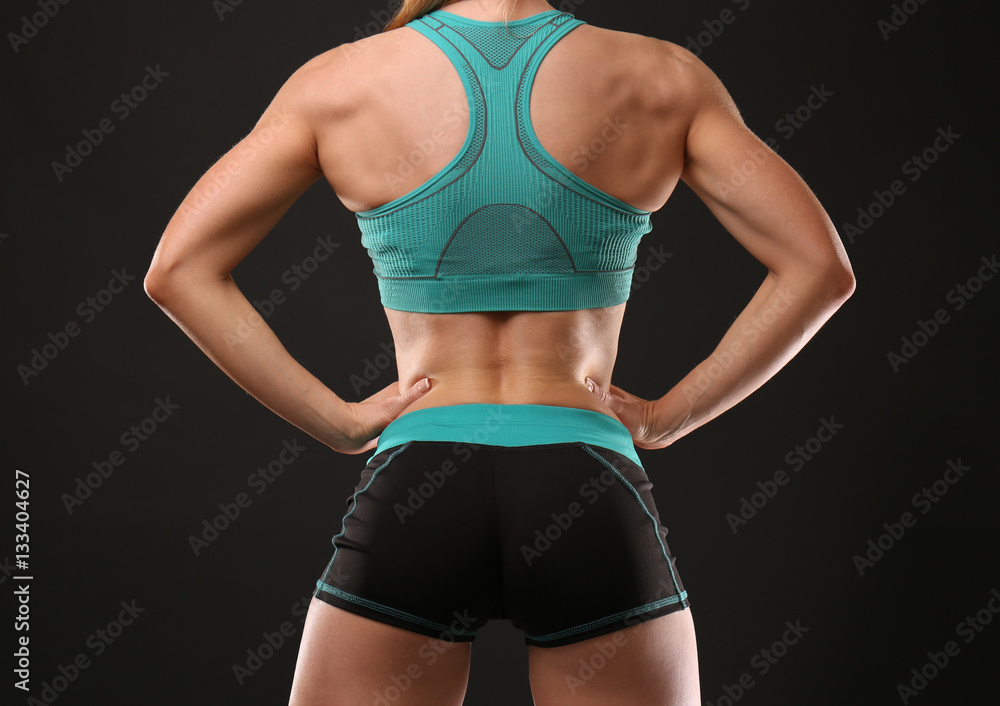 Young athletic woman on black background Young athletic woman on black background