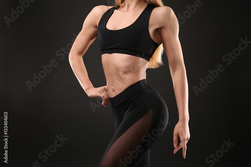 Young athletic woman on black background, closeup © Africa Studio