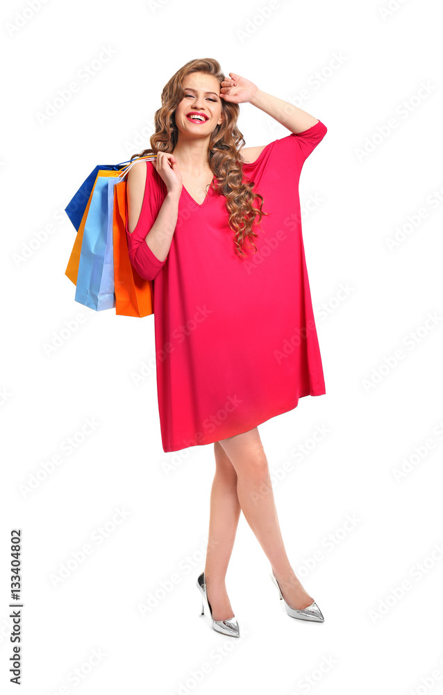Woman in pink dress with shopping bags on white background Woman in pink dress with shopping bags on white background