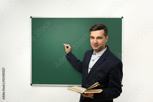 Handsome young teacher near...