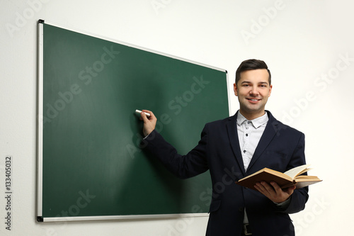 Handsome young teacher near...