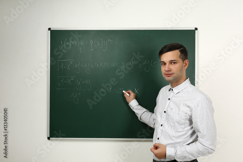 Handsome young teacher expl...