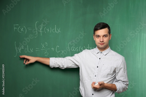 Handsome young teacher expl...
