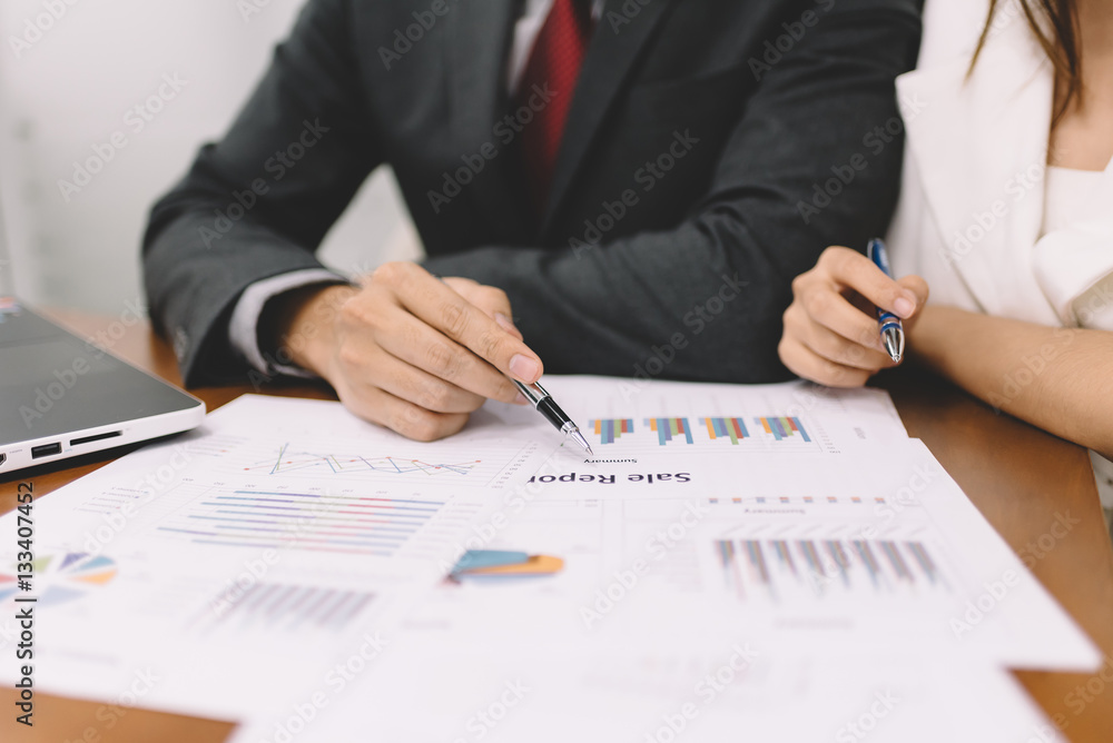 Businessman and woman discussing in business meeting with document on the table Businessman and woman discussing in business meeting with document on the table