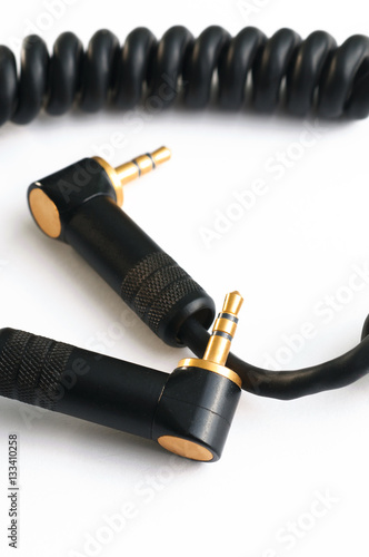 Black audio instrumental cable with two gold stereo plugs isolat