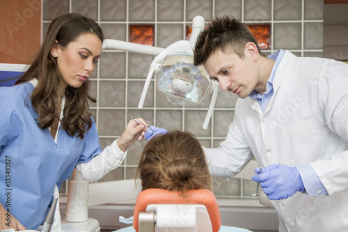 Young woman getting dental treatment in dentist office