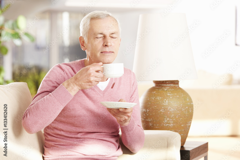 Senior man chilling at home while drinking a cup of coffee Senior man chilling at home while drinking a cup of coffee