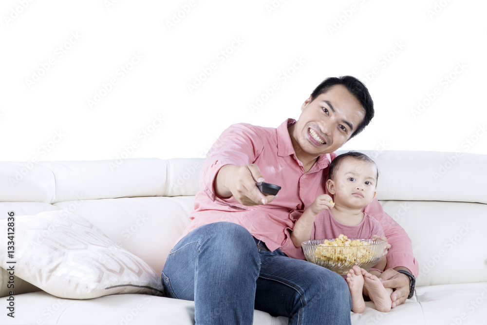 Young man and daughter watching TV