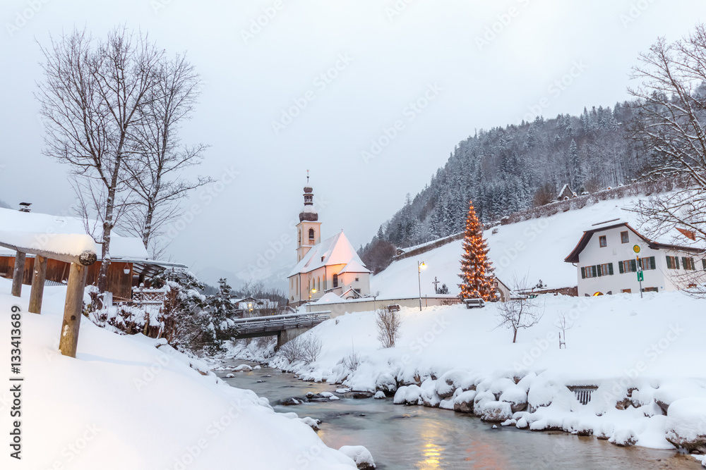 Church St. Sebastian in Ramsau Bavaria n the morning on a foggy morning with Christmas tree