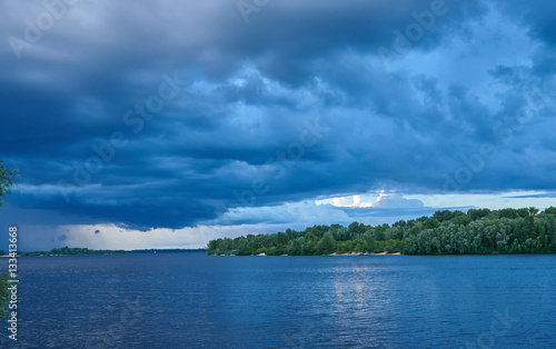 Landscape. The wide river, the sandy coast of the river overgrow