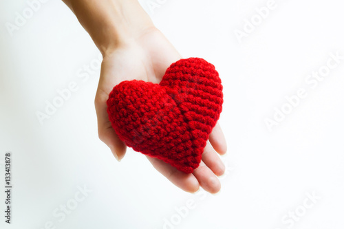 Woman hand holding red crocheted heart. Valentine s Day. Symbol of love.