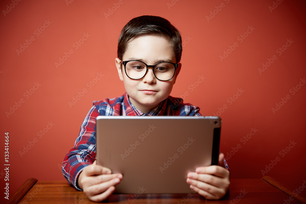 cute boy playing tablet computer cute boy playing tablet computer