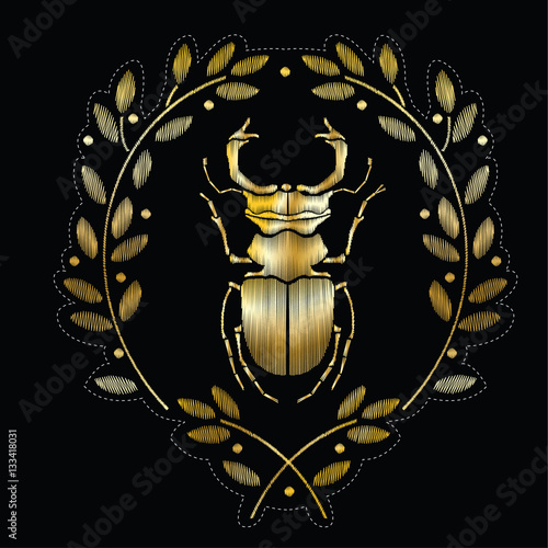 Embroidered coat of arms with beetle. Vector decorative element for embroidery, patches and stickers