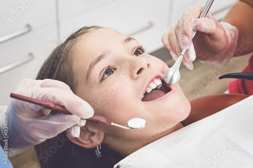 Young girl with open mouth at the Dentist photo