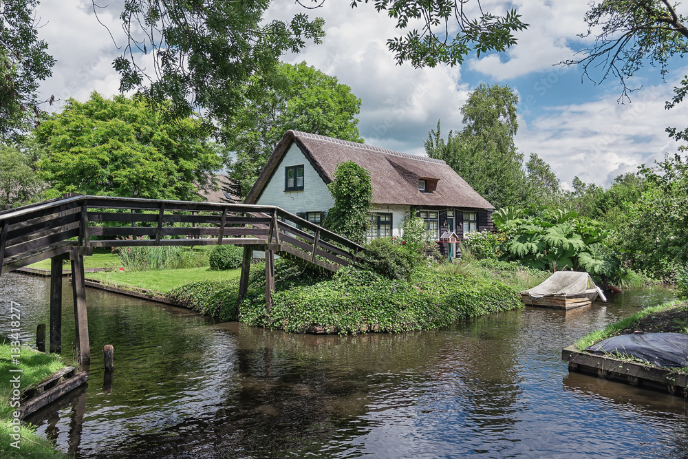 Giethoorn in The Netherlands with its typical thatched cottages and ditches Giethoorn in The Netherlands with its typical thatched cottages and ditches