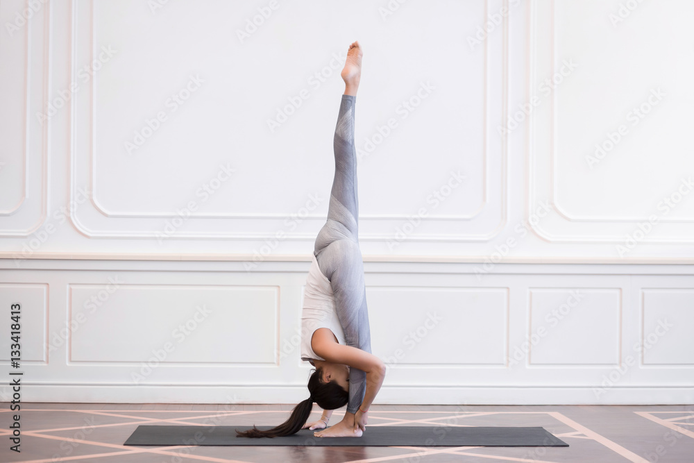 Young woman in white doing yoga pose Young woman in white doing yoga pose