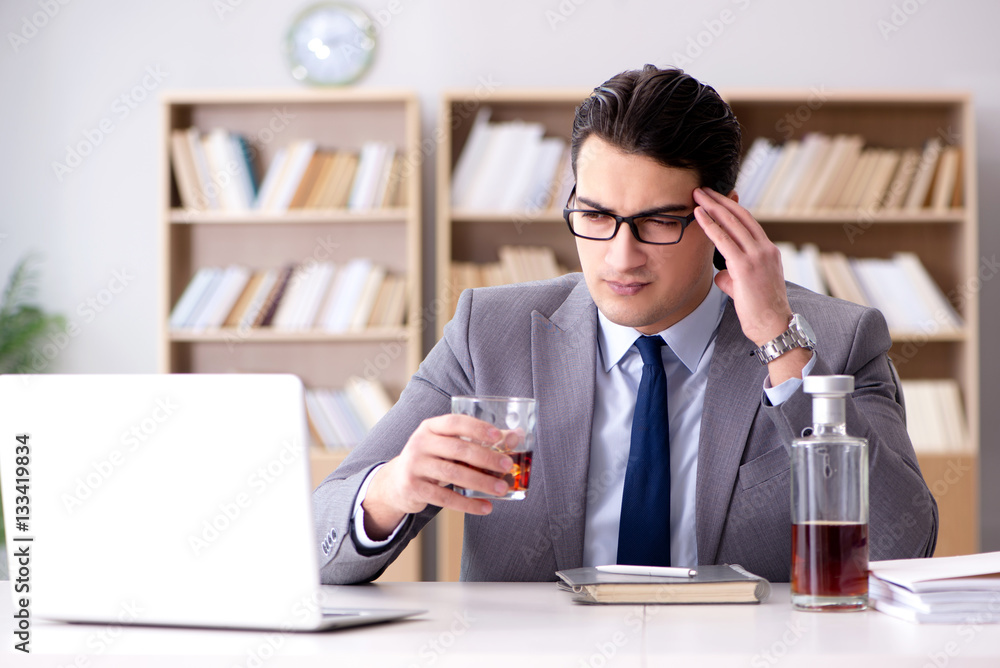Young businessman drinking from stress Young businessman drinking from stress