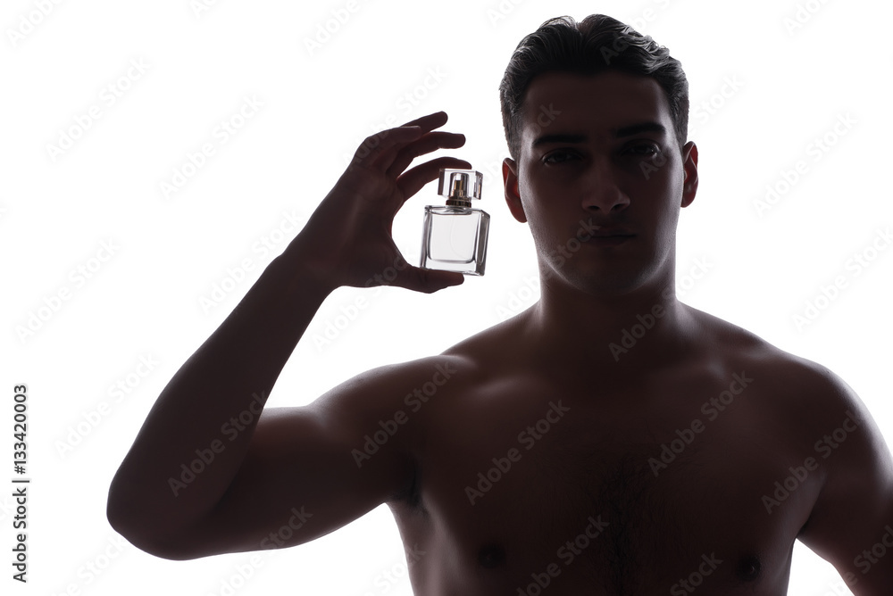 Fototapeta premium Sexy man with bottle of perfume