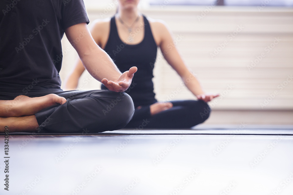 Young couple meditating together Young couple meditating together