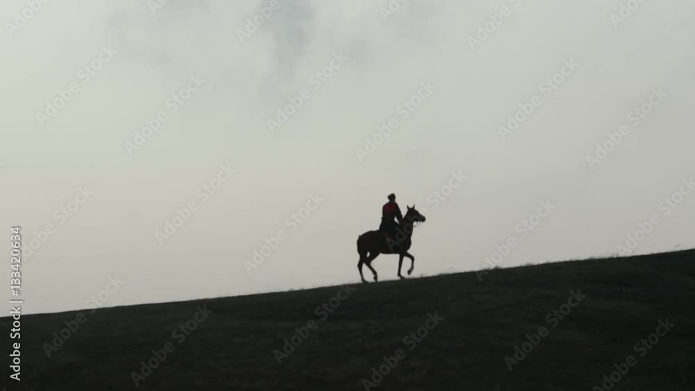 Cossack on horseback galloping over the hill Cossack on horseback galloping over the hill