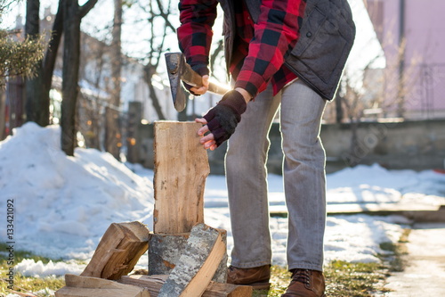 Man chopping firewood in the yard