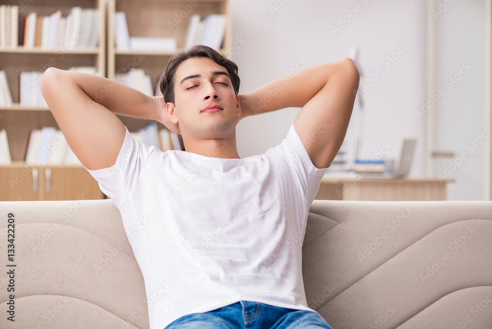 Young man relaxing sitting in couch sofa Young man relaxing sitting in couch sofa