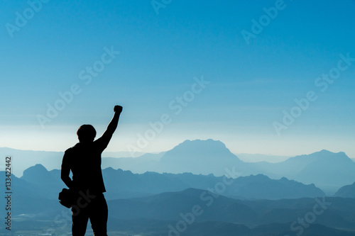 Traveler Man right hand raised,Mountains landscape on background
