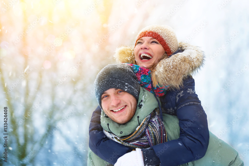 Happy Young Couple in Winter Park laughing and having fun. Family Outdoors. Happy Young Couple in Winter Park laughing and having fun. Family Outdoors.